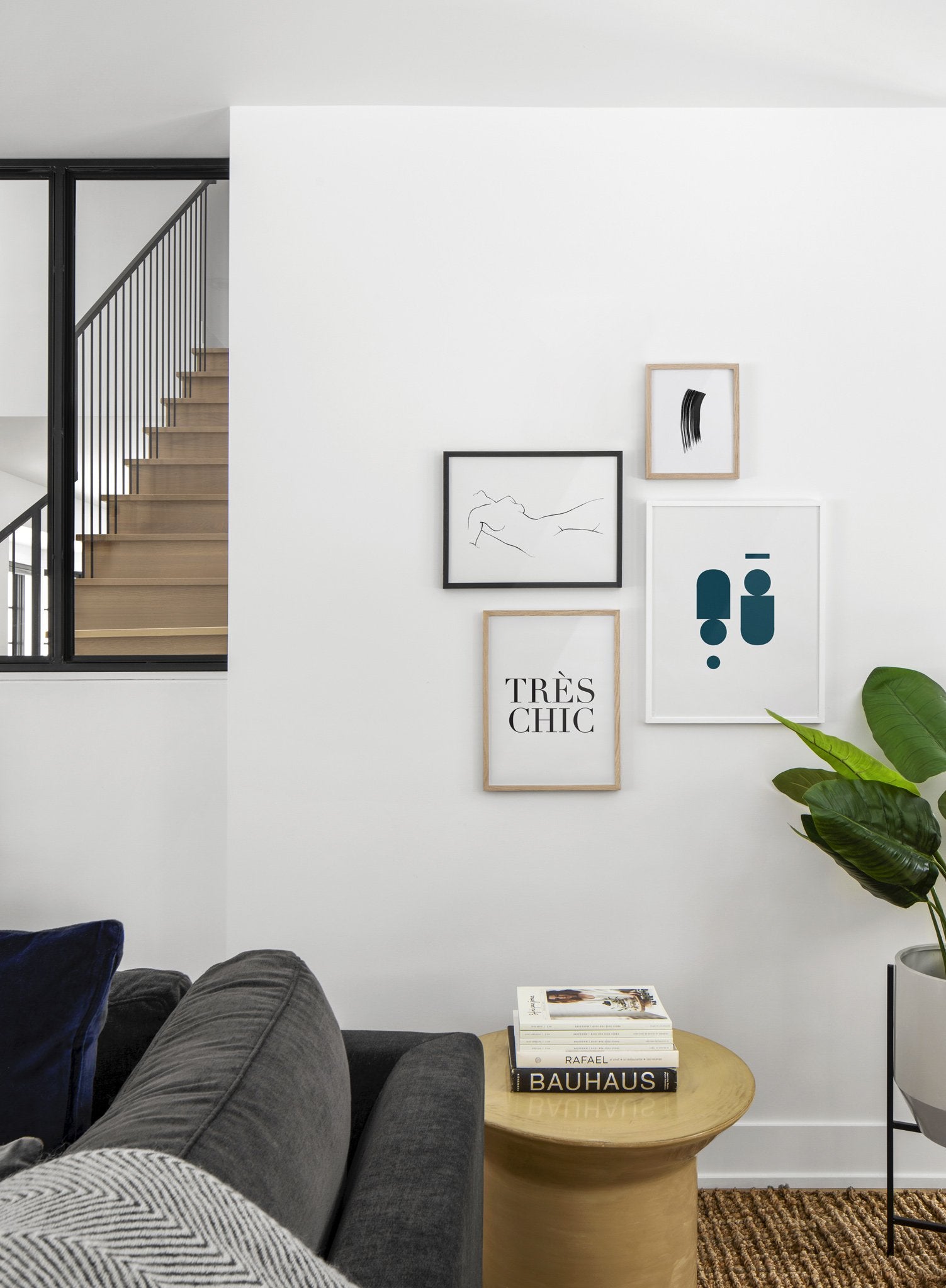 Scandinavian poster by Opposite Wall with black and white graphic typography design of Très Chic - Living room with gallery wall