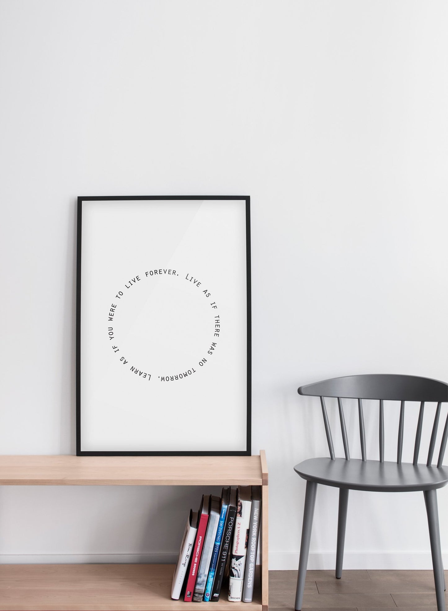 Modern minimalist poster by Opposite Wall with trendy round black and white Live and Learn typo design - Living room with a grey chair