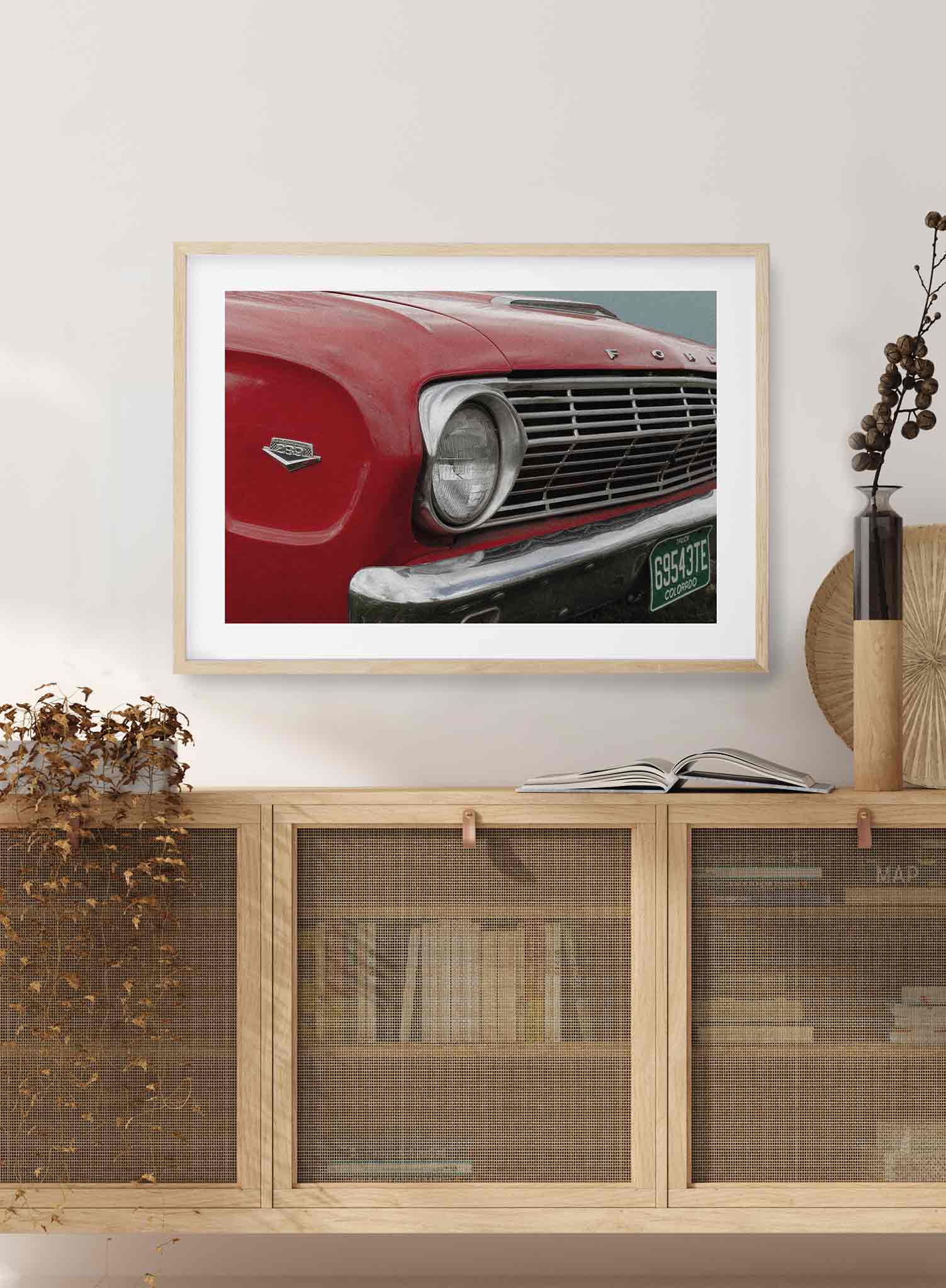 ‘50s Bumper is a vintage photography poster of a red Ford car's bumper by Opposite Wall.