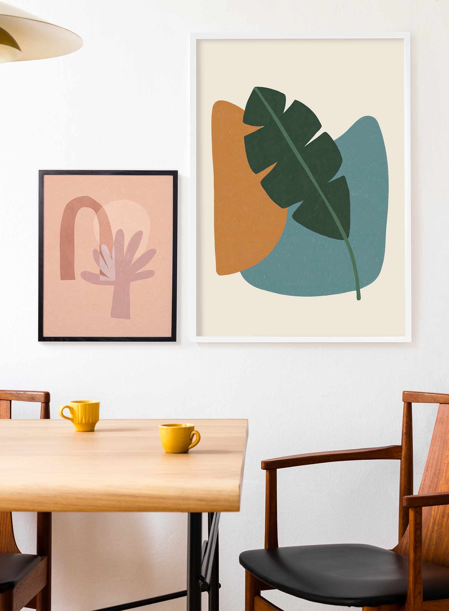 Banana Leaf is a minimalist a green banana leaf placed on top of an orange and teal circular shapes by Opposite Wall.