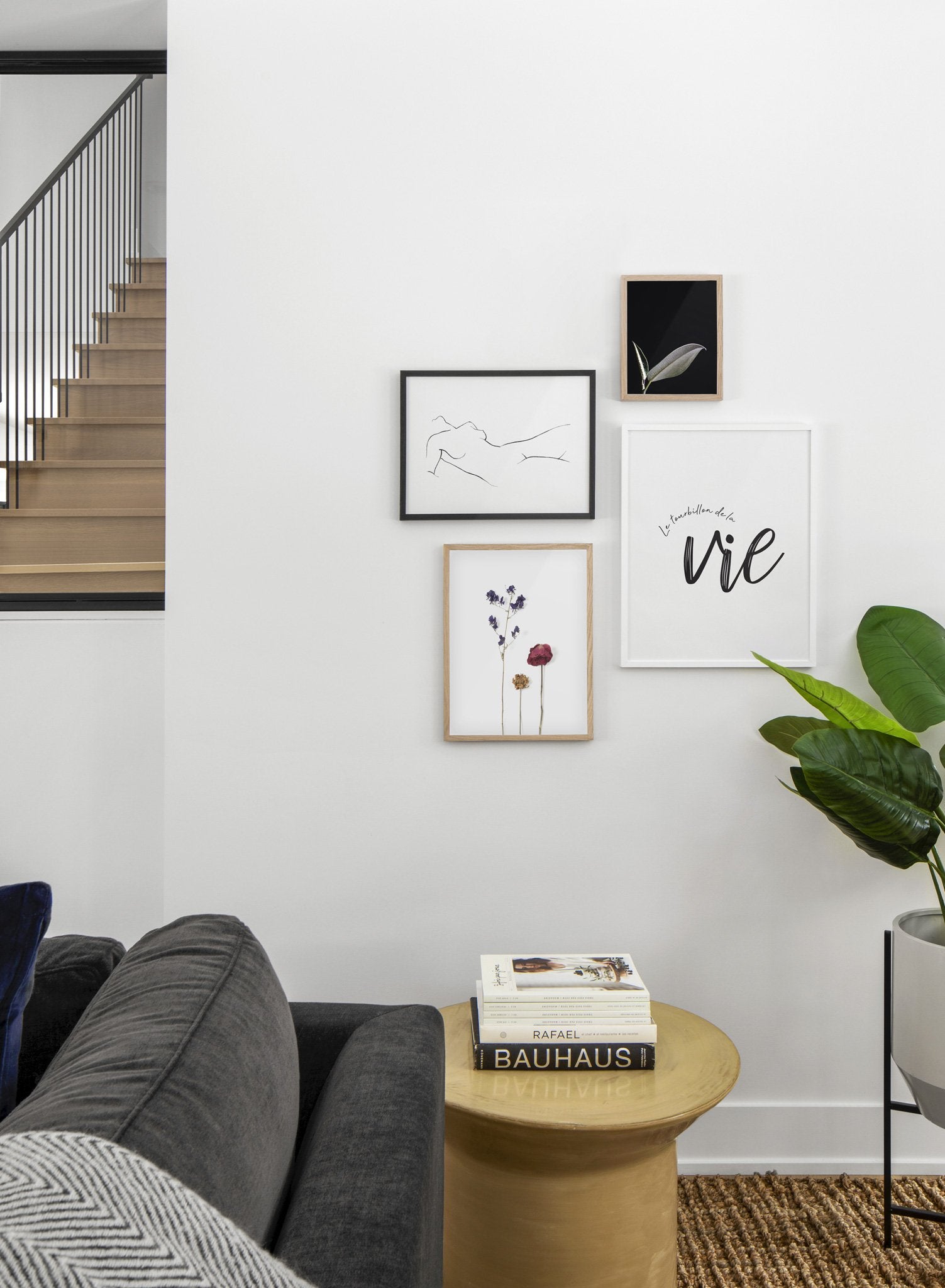 Scandinavian poster by Opposite Wall with black and white graphic typography design of Le tourbillon de la vie - Living room with a gallery wall