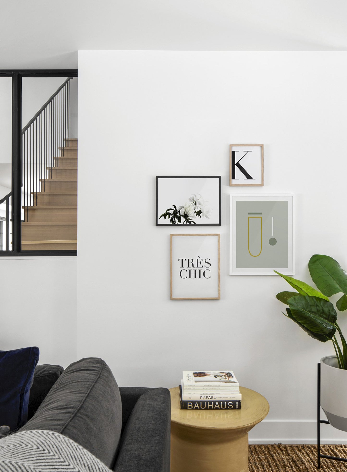 Scandinavian poster by Opposite Wall with black and white graphic typography design of the letter K - Living room with a staircase - Gallery Wall quadruple