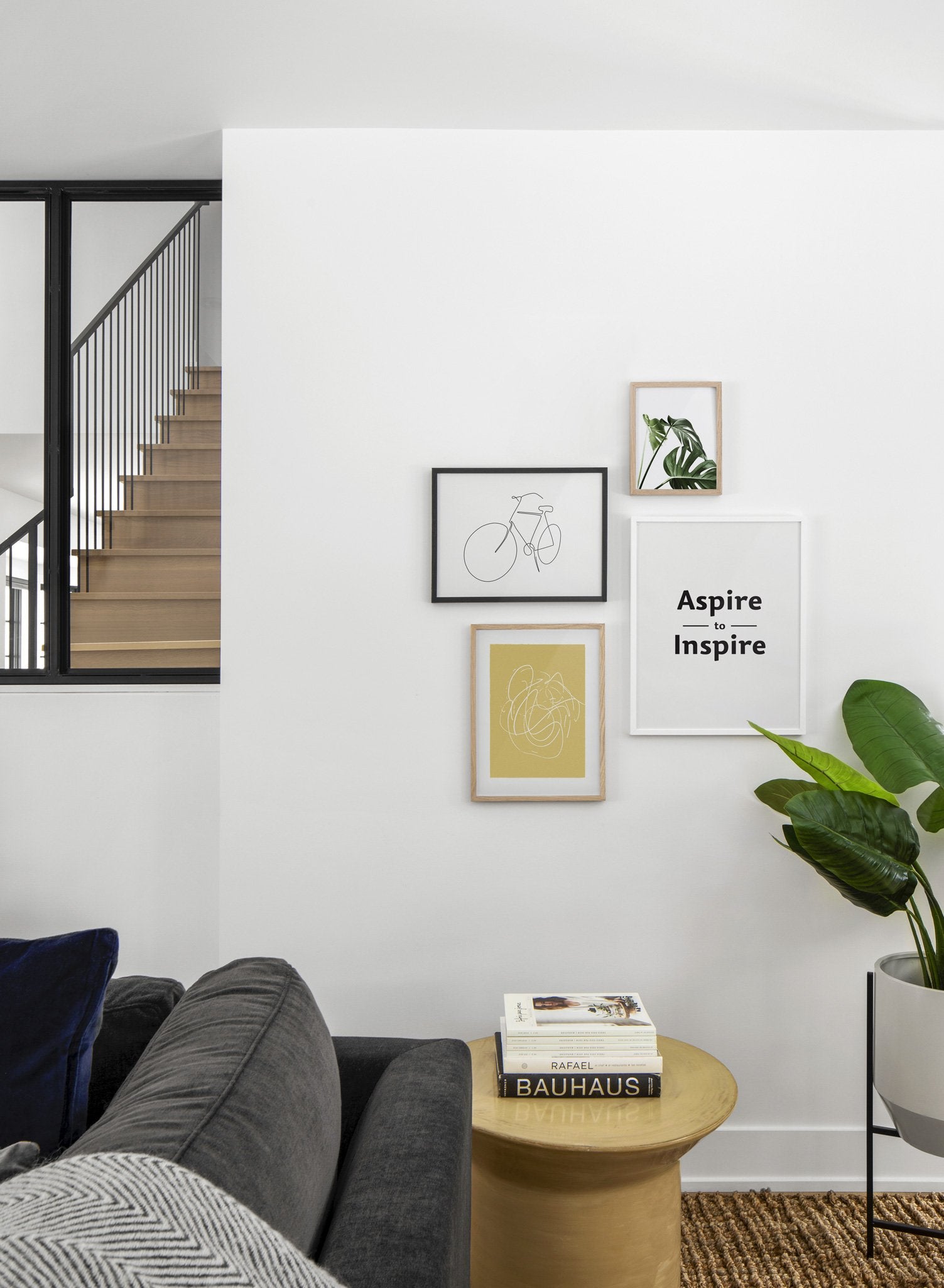 Scandinavian poster by Opposite Wall with black and white graphic typography design of Aspire to Inspire - Living room with Gallery Wall