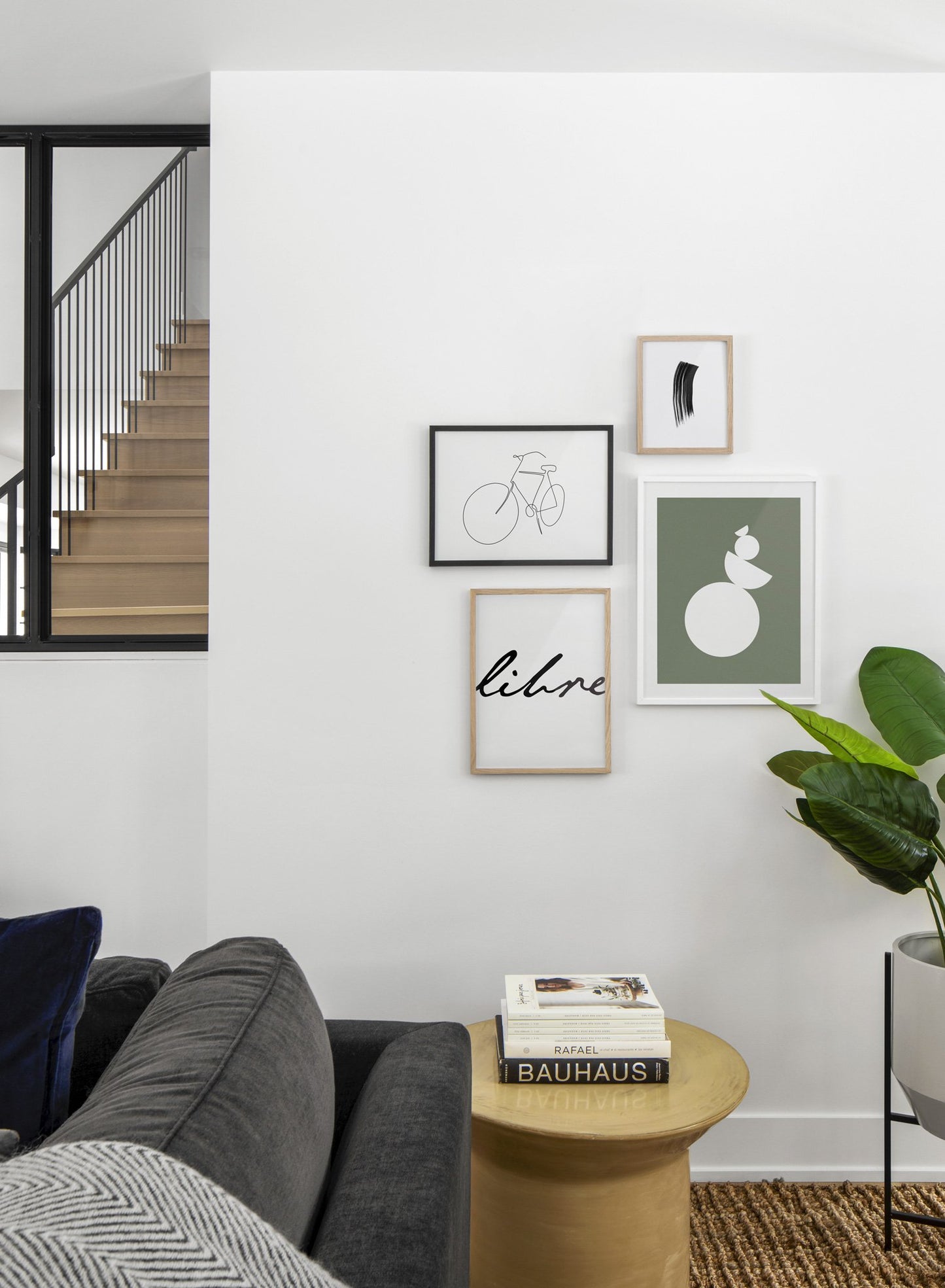 Scandinavian poster by Opposite Wall with black and white graphic typography design of Libre - Living room with a gallery wall quadruple