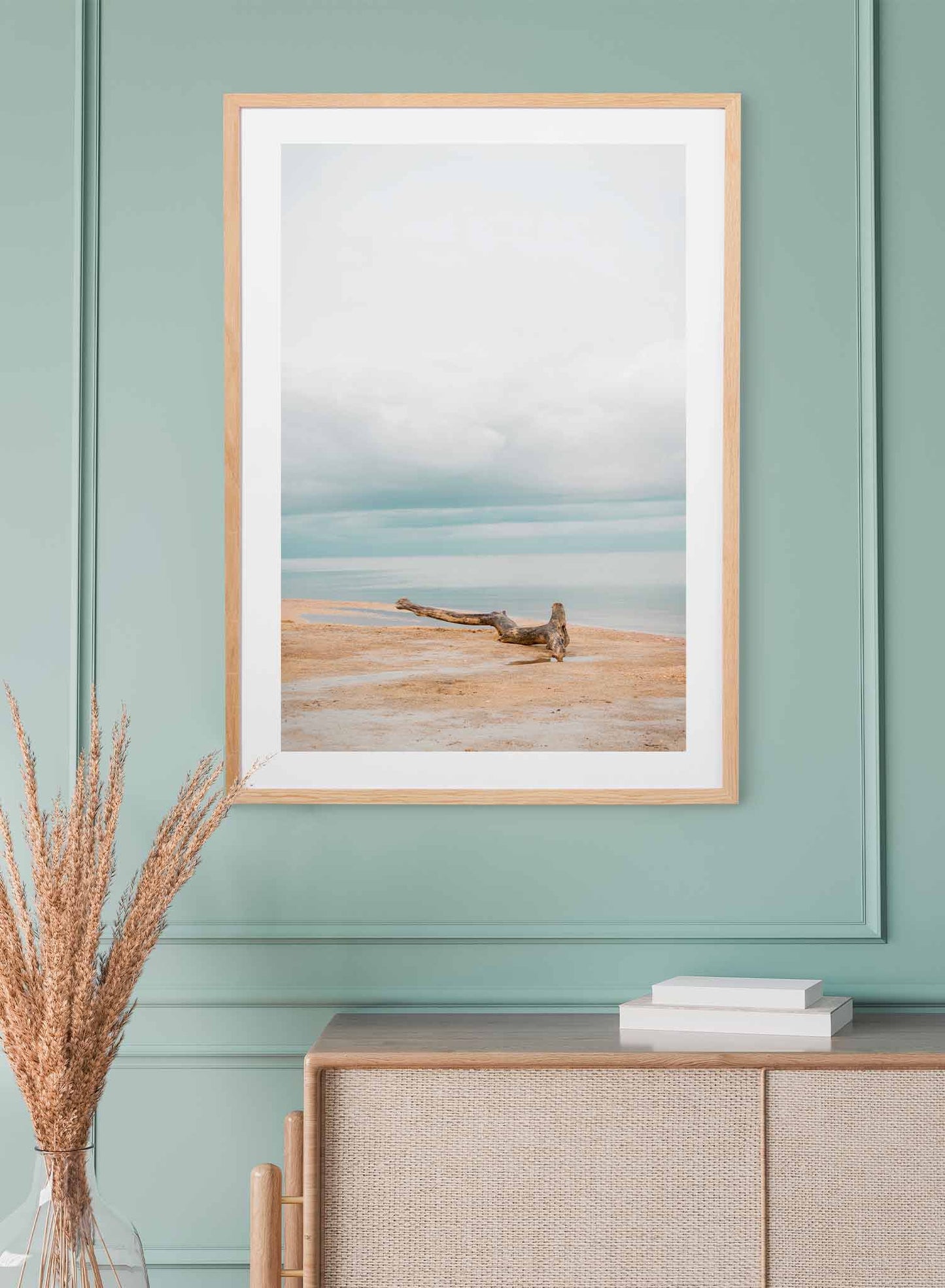 Coastal Morning is a minimalist photography of a calm beach overlooking a cloudy blue sky with a driftwood as focal point by Opposite Wall.