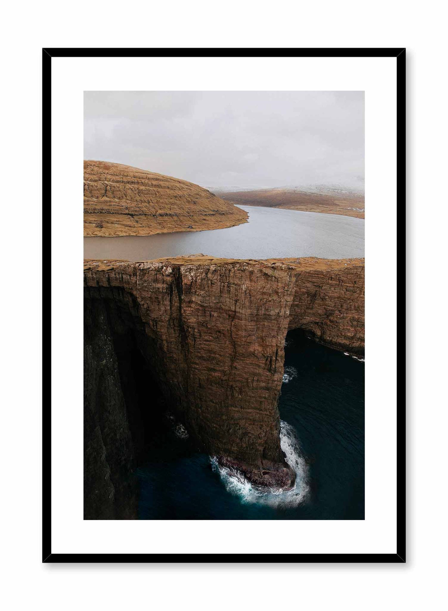 Serene Precipice' is a landscape photography poster by Opposite Wall of a tranquil lake overlooking the edge of a tall cliff in the Faroe Islands.